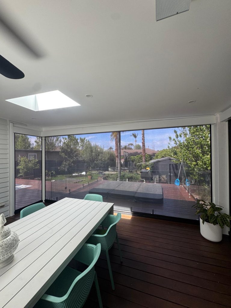 This project in Cheltenham required a tailored approach to navigate a tricky corner on a pergola. We utilised a custom removable post on the corner to allow a clear walk-way when the blinds are retracted and post is removed. The client chose a 99% blockout mesh for wind, rain and sun protection without sacrificing their view. The job also required custom Colorbond flashings to infill the gap above the pelmets due to the pitch of the roof.
